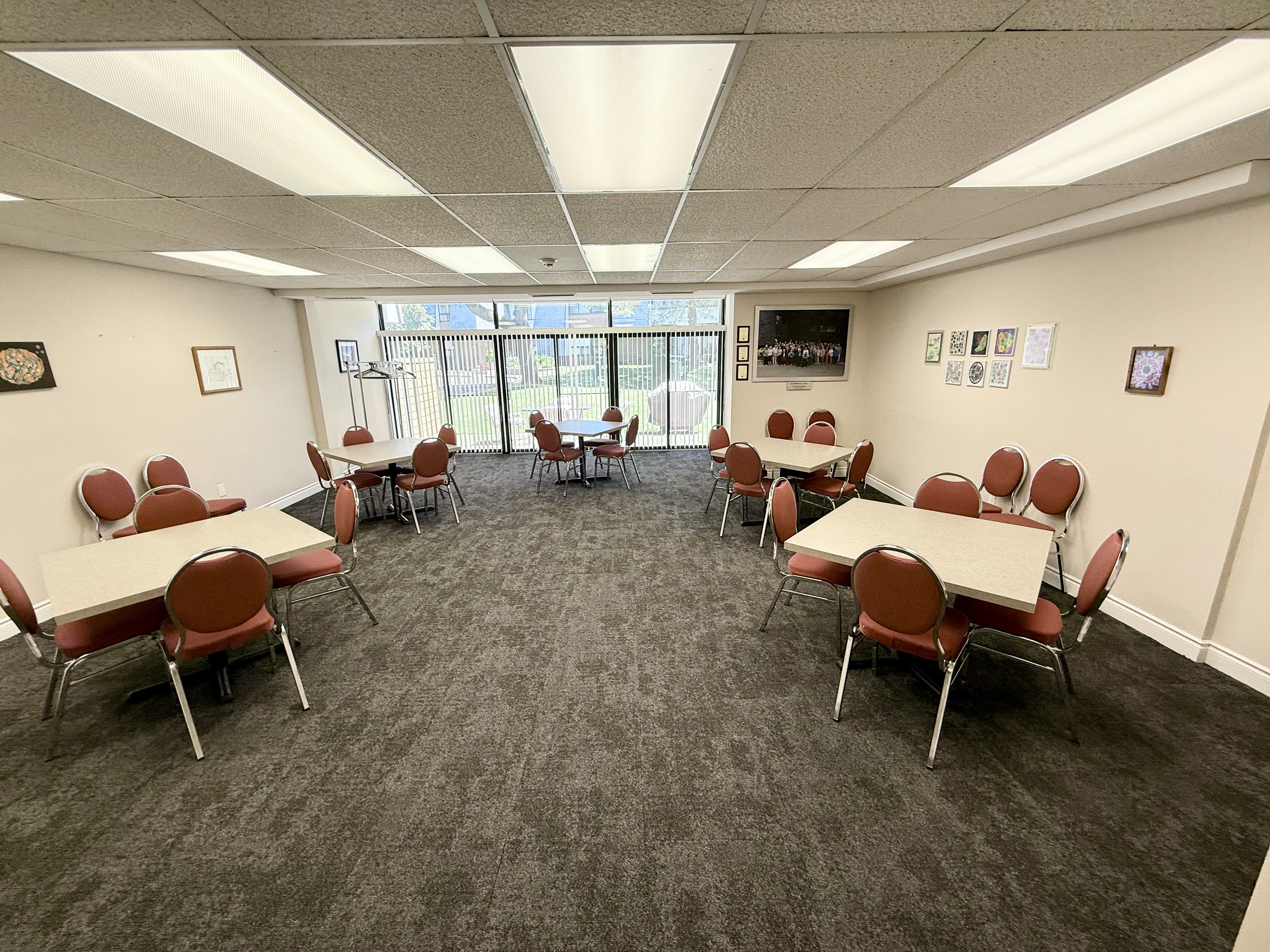 A living room with a table, sofa, and plants. A stand comprising four interlocking foam jigsaw puzzles is placed on a tabl...